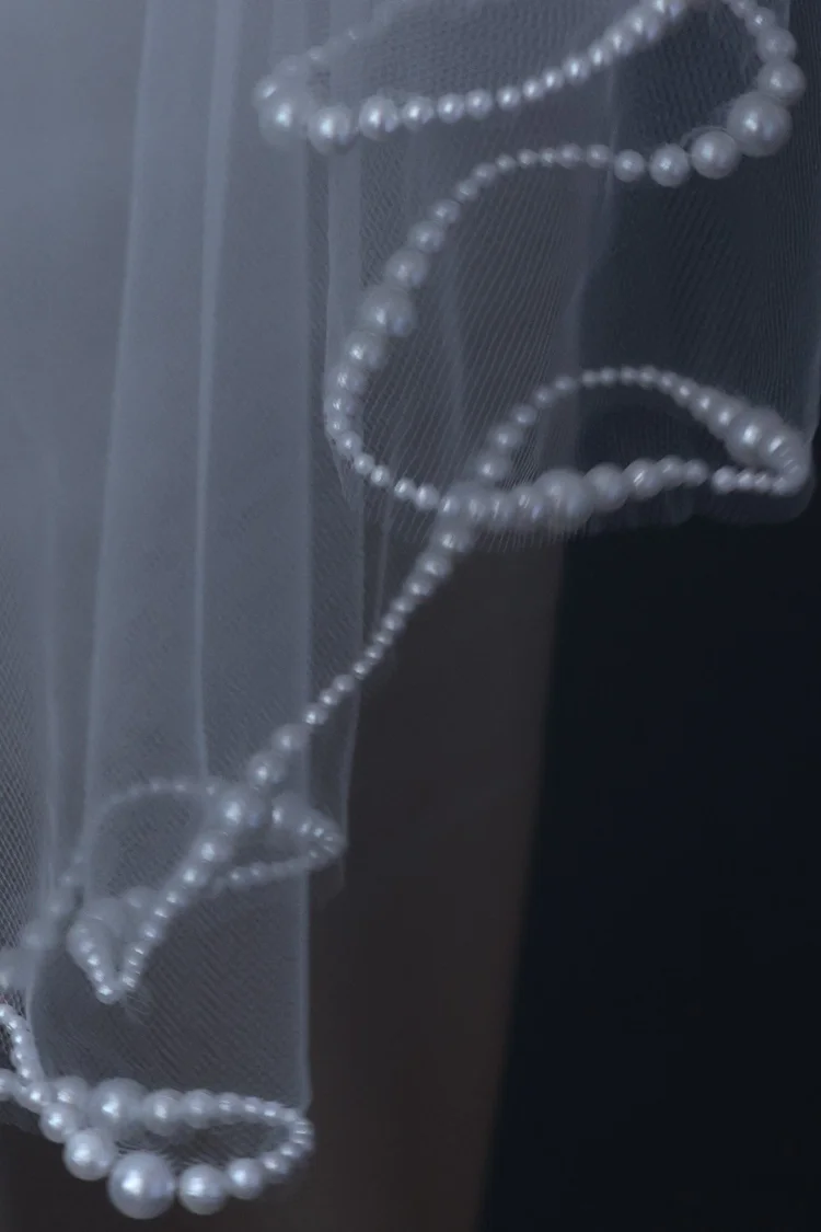 Pearl trimmed wavy cut fingertip length Maho Bay bridal veil by
